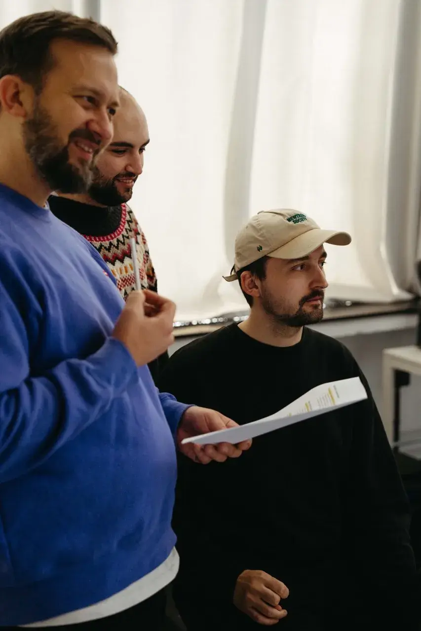 Directing discussion on set: The production team and Director of Photography reviewing the script for the FDP TV commercial.