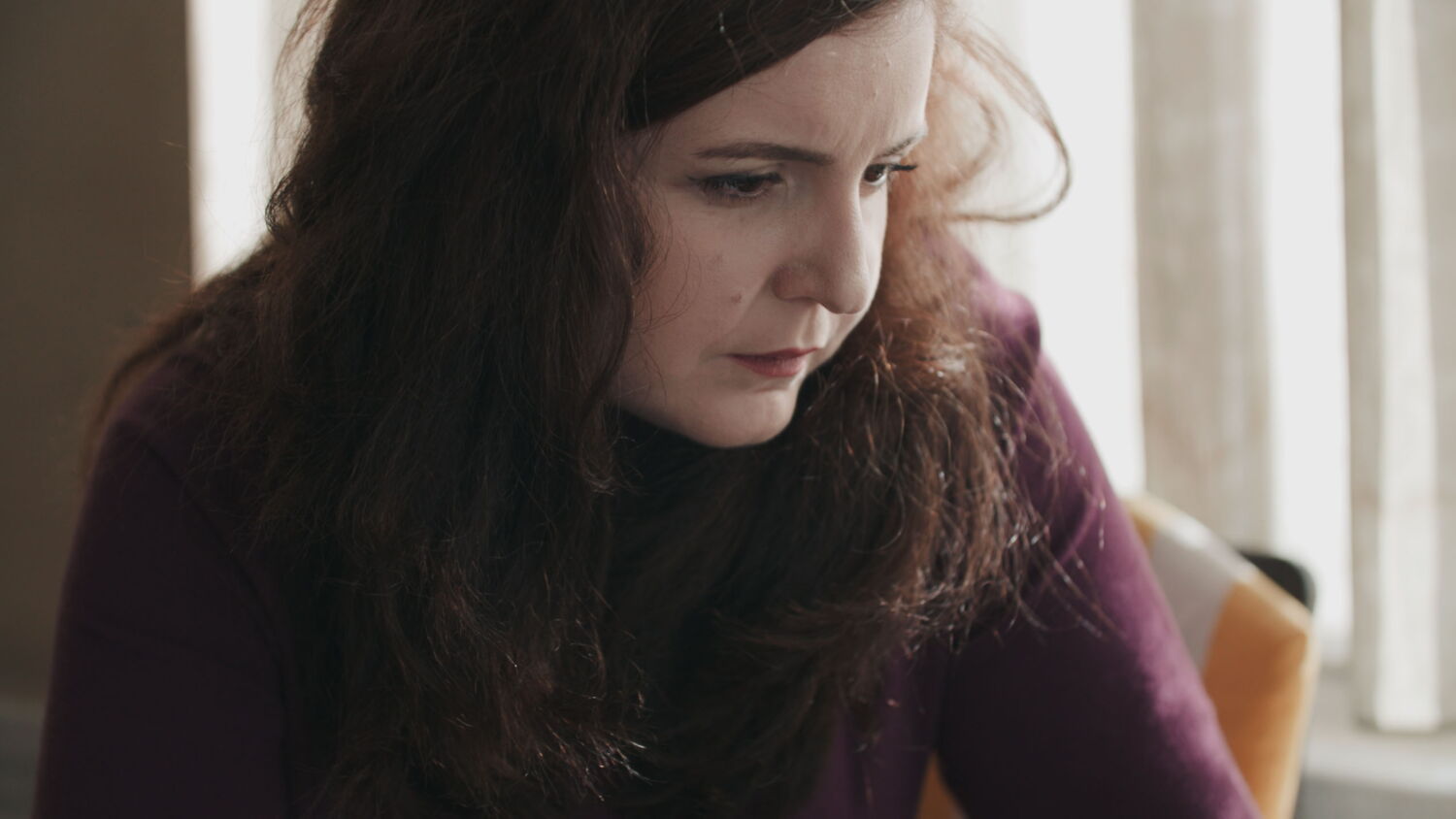 Pensive close-up of an activist reflecting on the difficult political situation and the risks of her engagement.