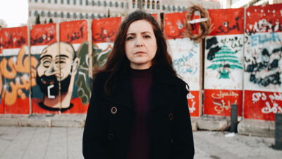 Video thumbnail: Portrait of a political activist standing in front of a graffiti wall in Beirut. Preview for the documentary film Women Leading Protests.