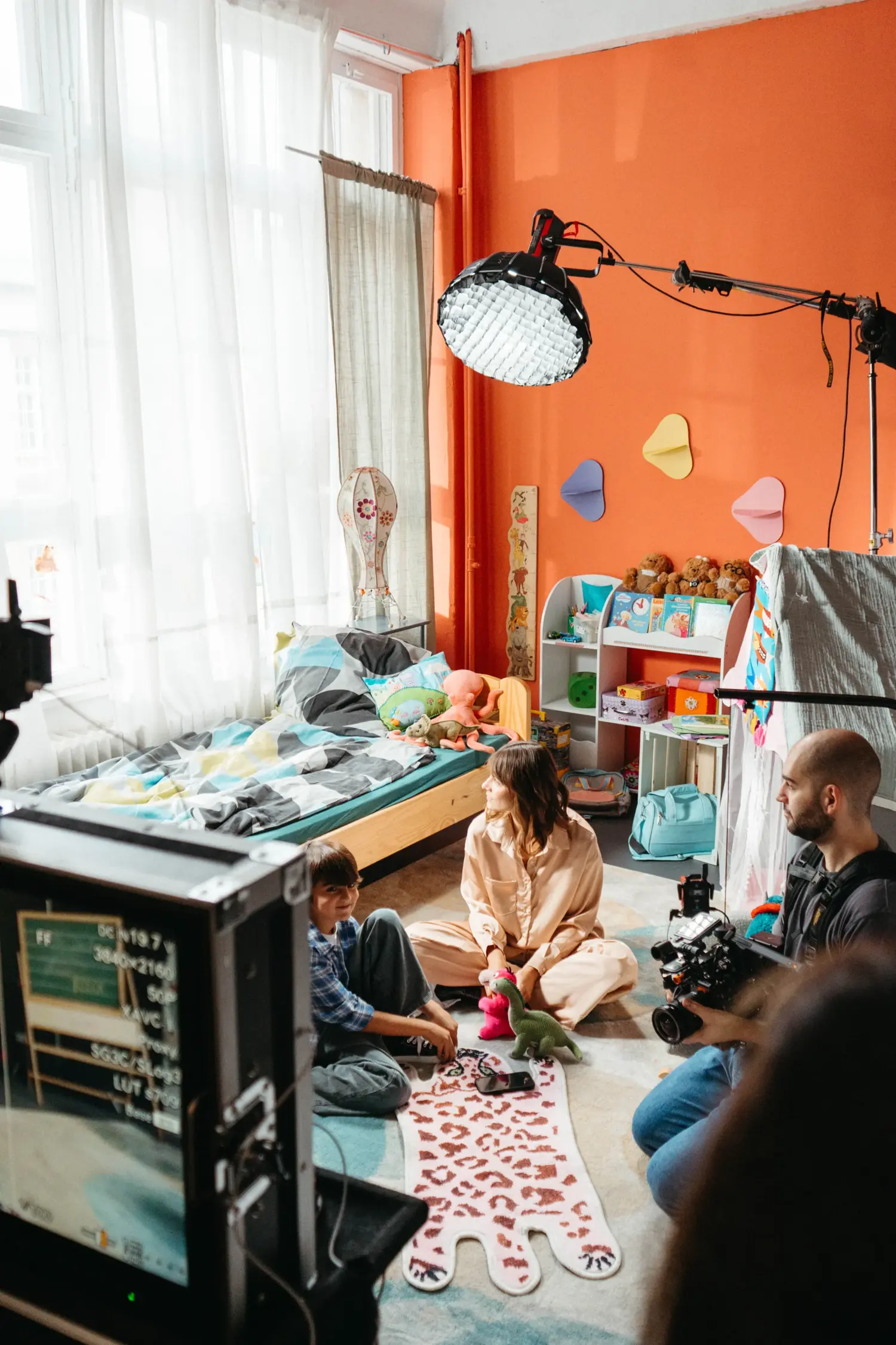 DoP Munir Werner filming a mother-child scene with Liene de Heer from a low angle in a kids' room set. Large softbox lighting in use.