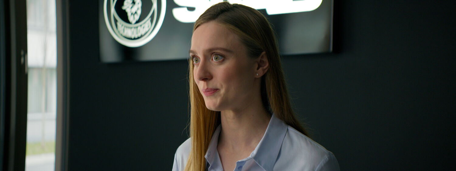 Close-up of a Saab receptionist reacting with surprise to the request for car spare parts.