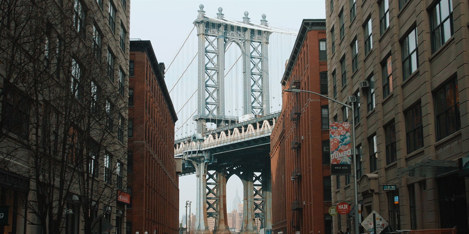 Iconic view of the Manhattan Bridge from Dumbo, an atmospheric filming location for the jazz documentary in New York.